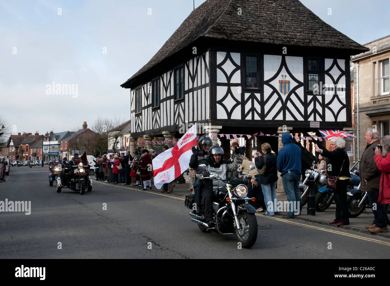 Harley Davidson rider with his St Georges Cross flag waving rides along Wootton Bassett High Street Stock Photo