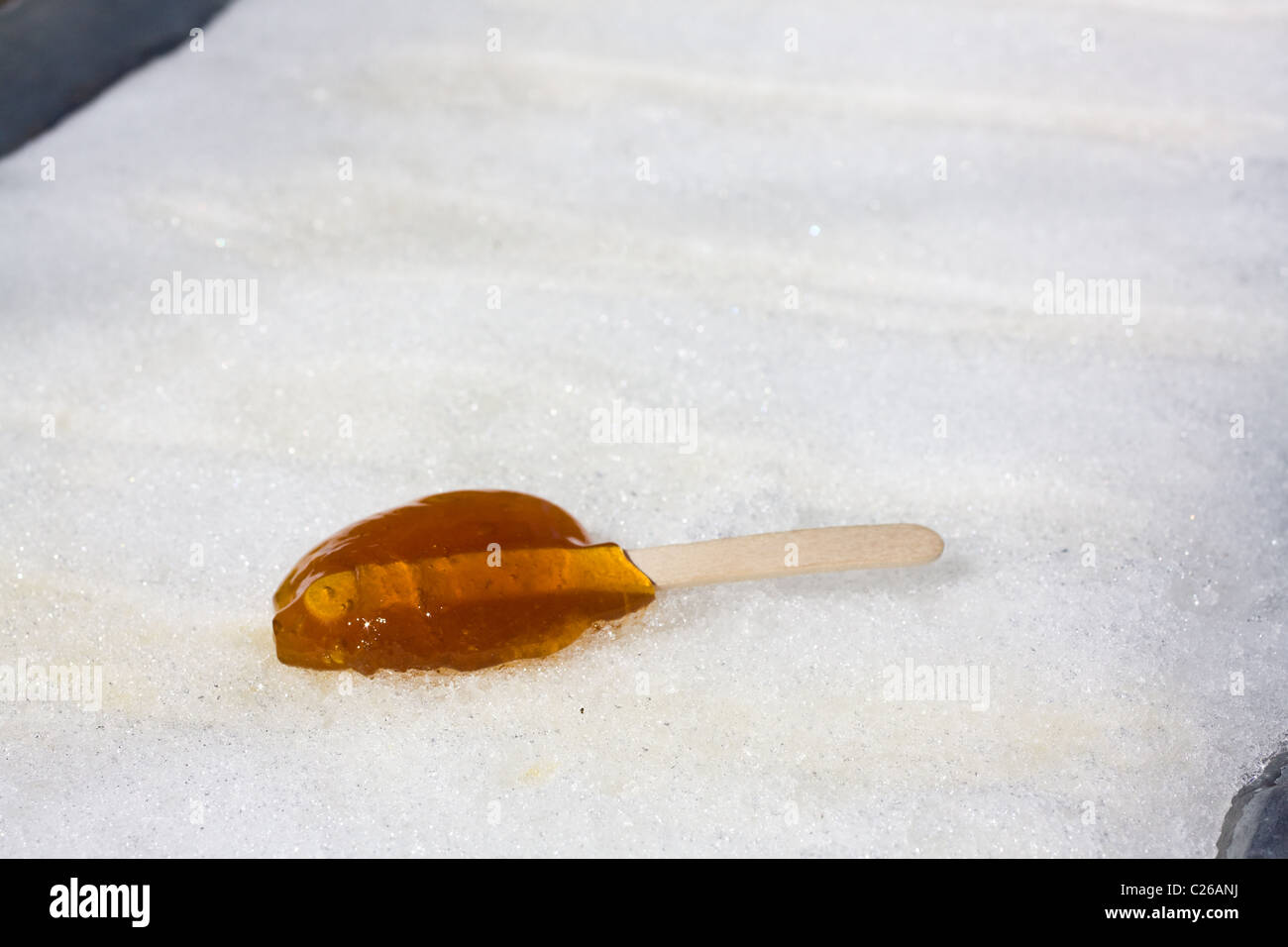 Hot maple syrup poured on snow also known as maple taffy or sugar on