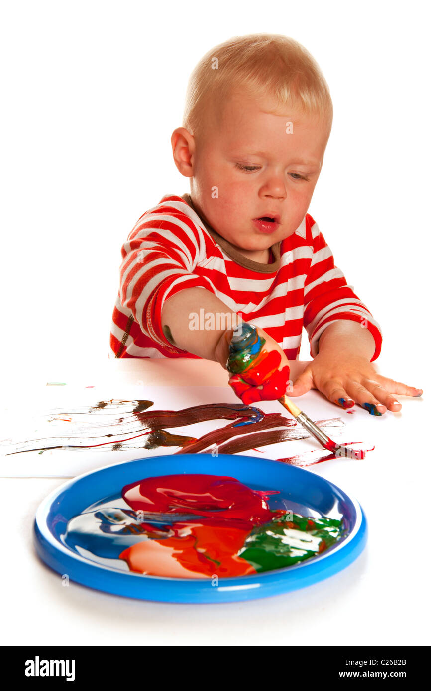 Little boy is painting and making a mess Stock Photo - Alamy