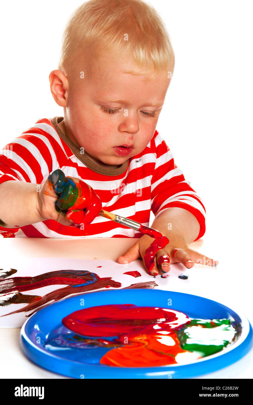 Little boy is painting and making a mess Stock Photo - Alamy