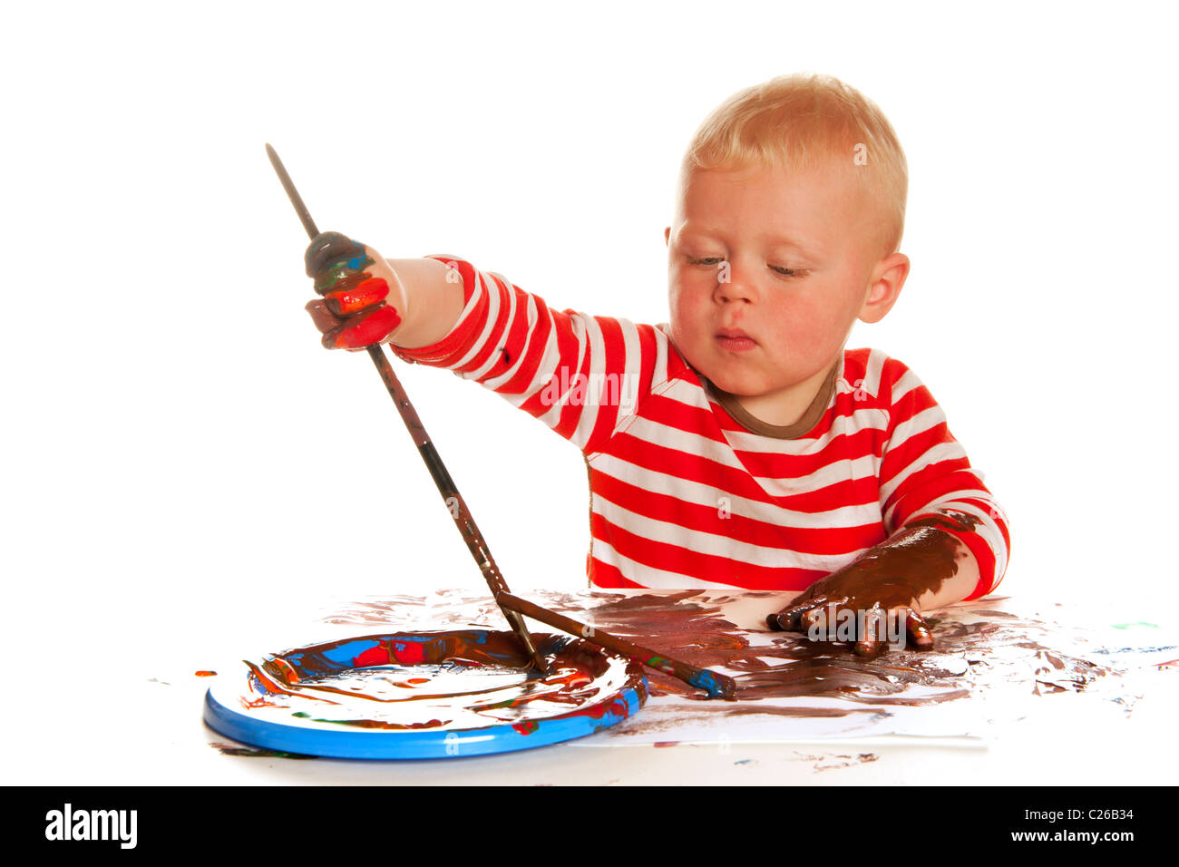 Little boy is painting and making a mess Stock Photo - Alamy