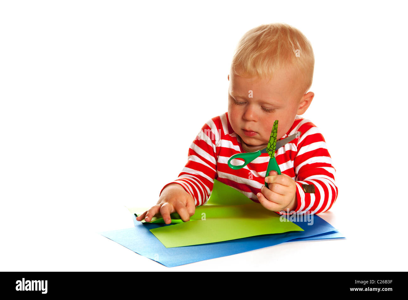 Little boy with papers and scissors isolated over white background ...