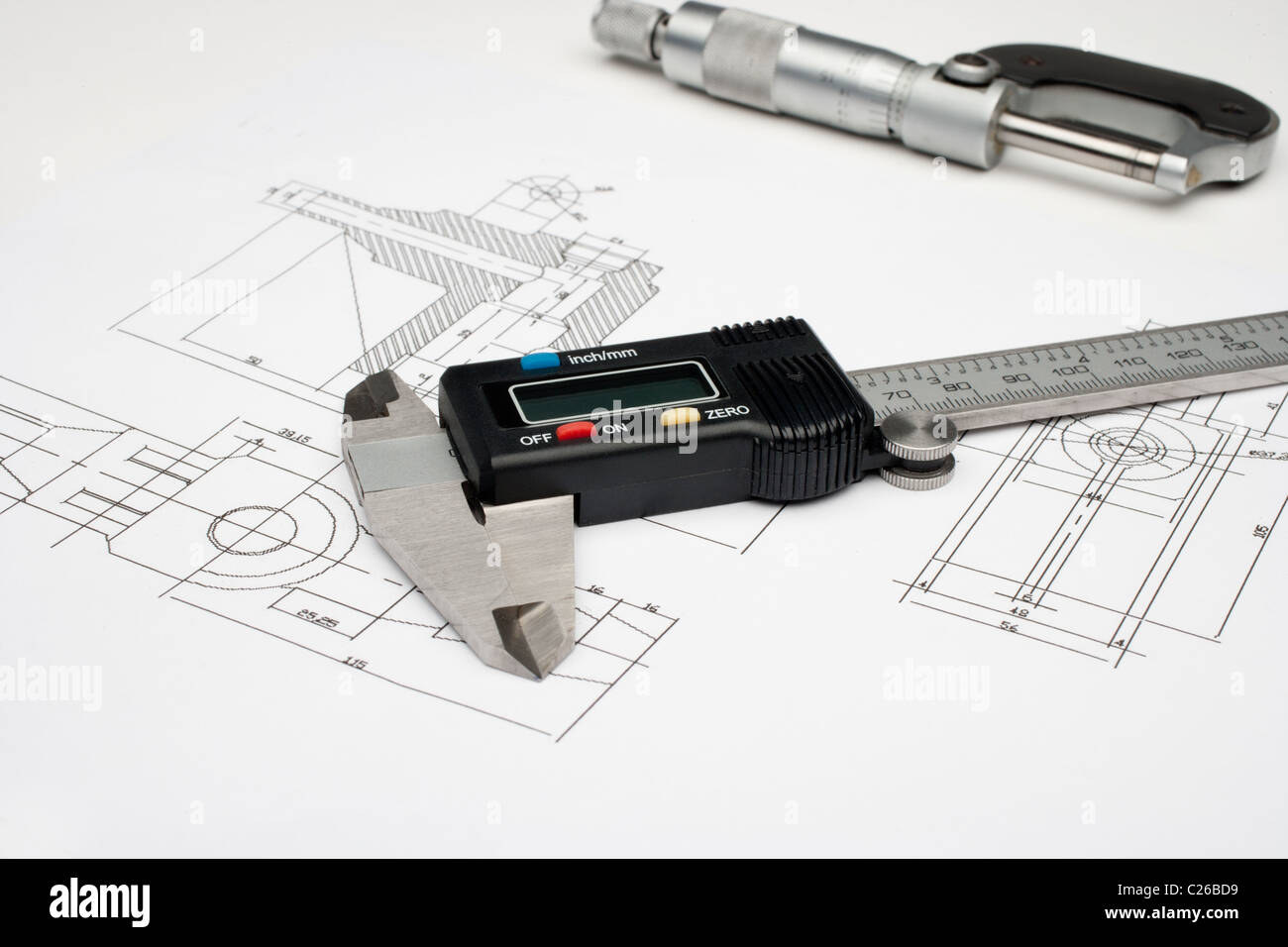 Horizontal image of a micrometer and digital caliper on a white drawing Stock Photo