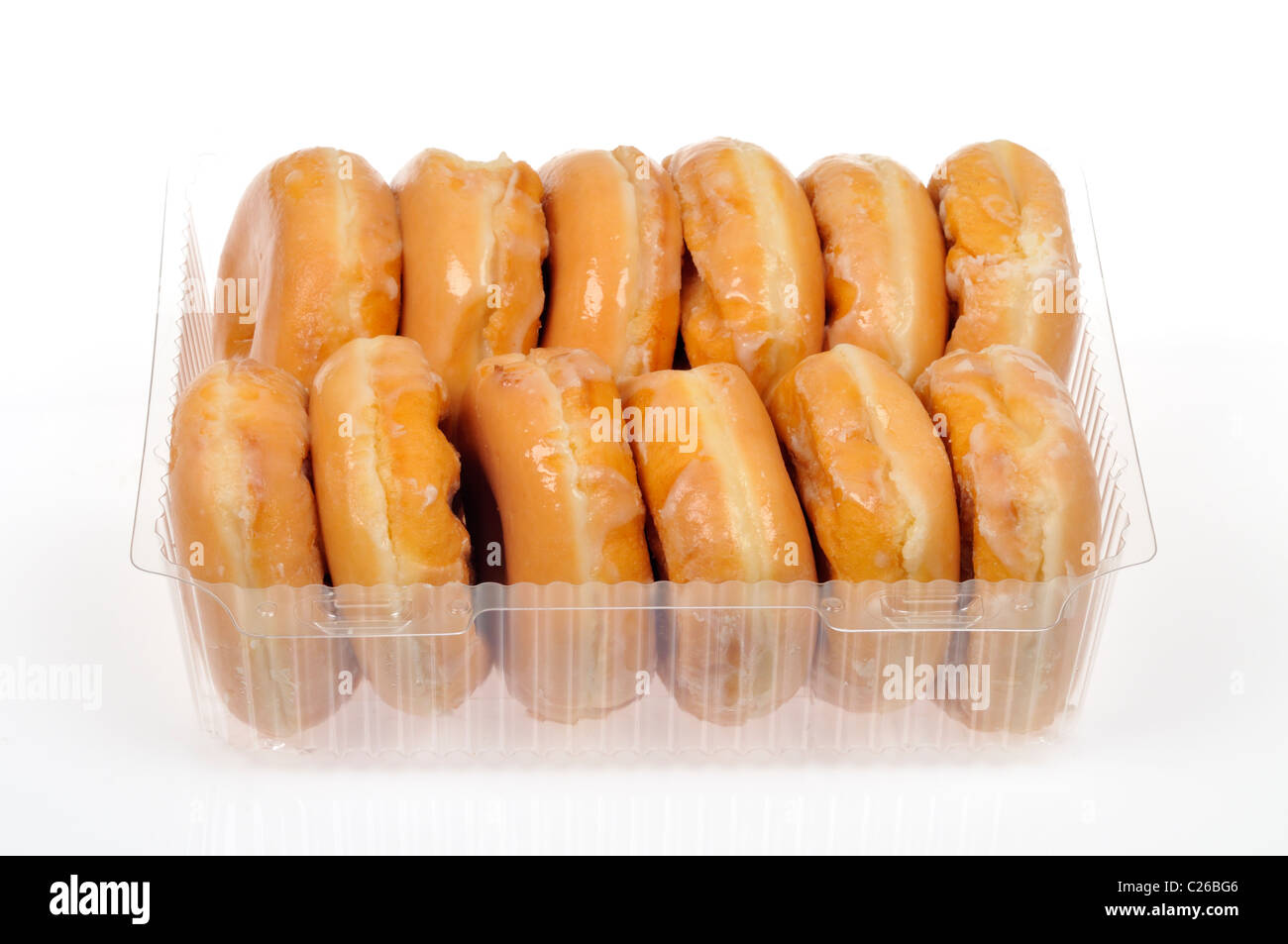 Pack of a dozen glazed doughnuts on white background, cutout. Stock Photo