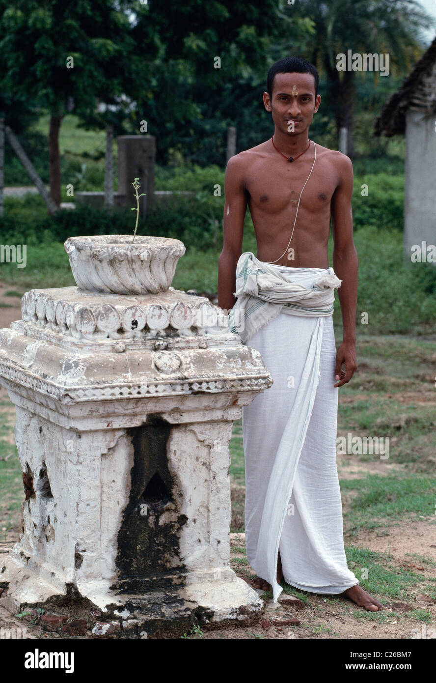 Wearing the Brahmin upper caste thread, a boy stands at his Hindu religious school learning the