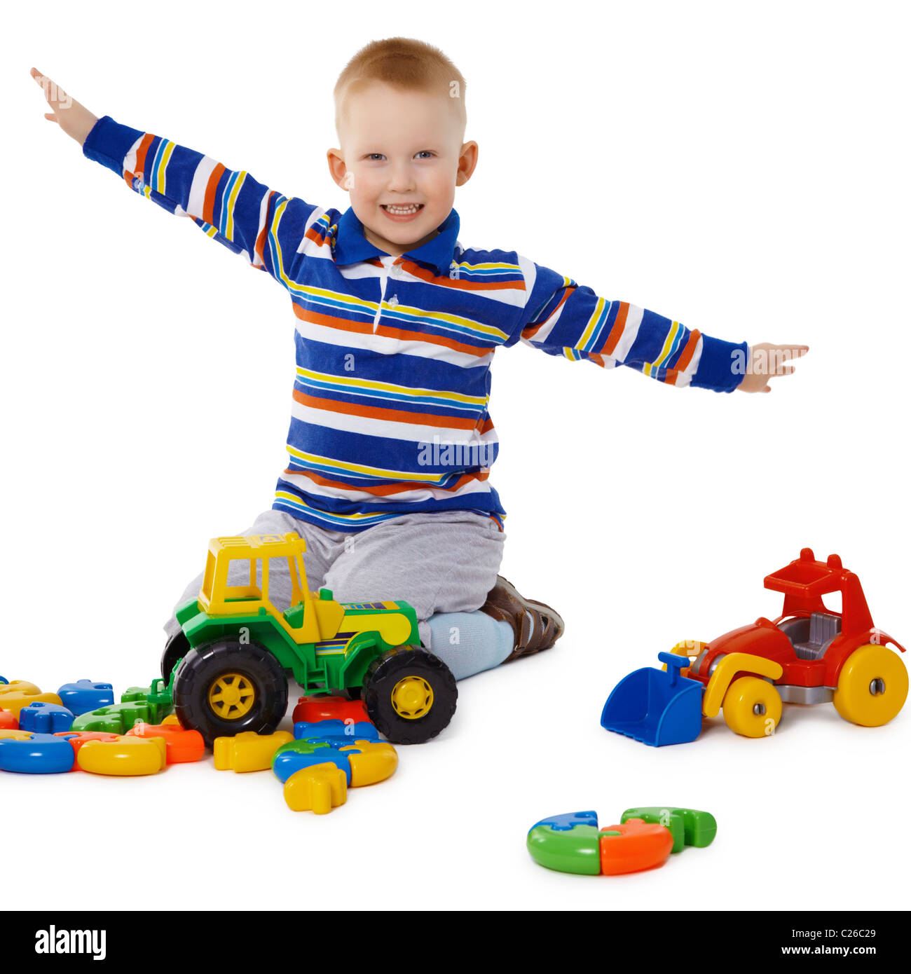 Little boy playing with colorful toys on the floor Stock Photo - Alamy