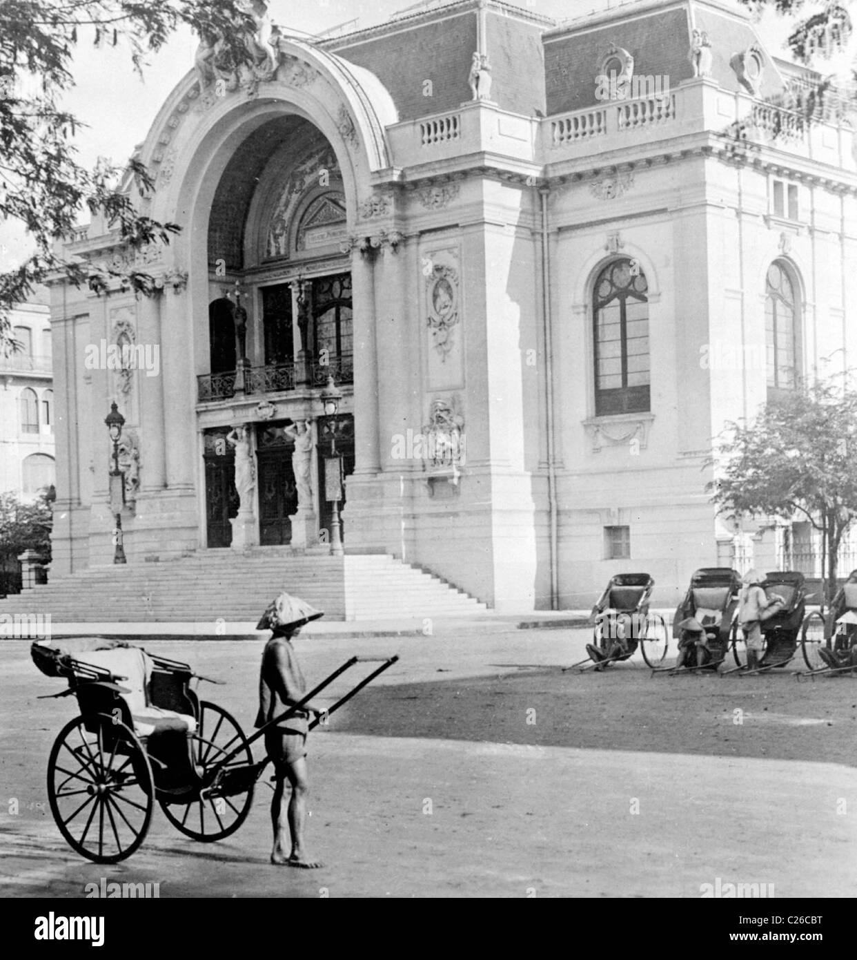 Municipal theatre and stand for 'malabars,' the oriental hansom cab, Saigon, Vietnam circa 1915 Stock Photo