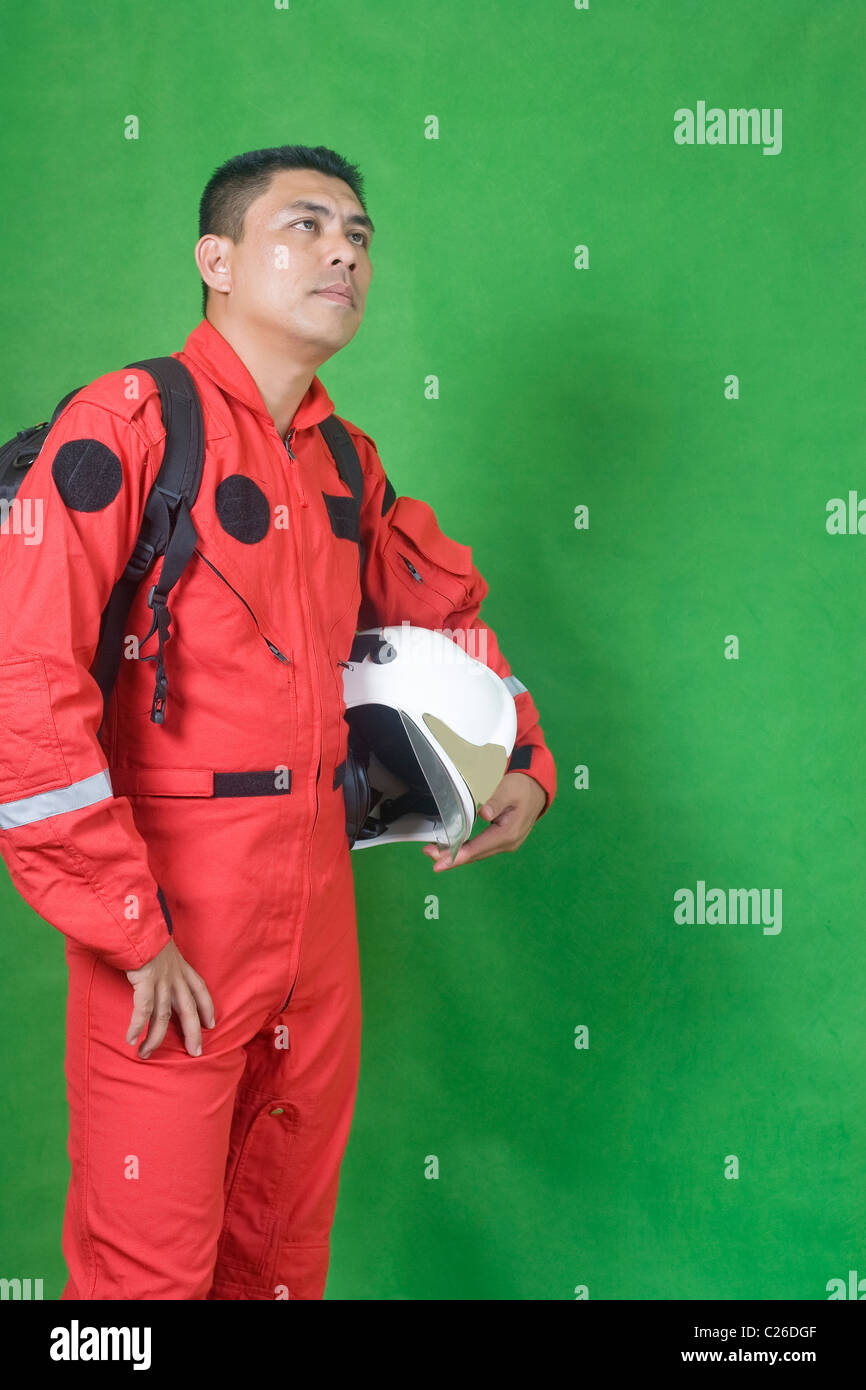 Portrait of man firefighter isolated on green Stock Photo