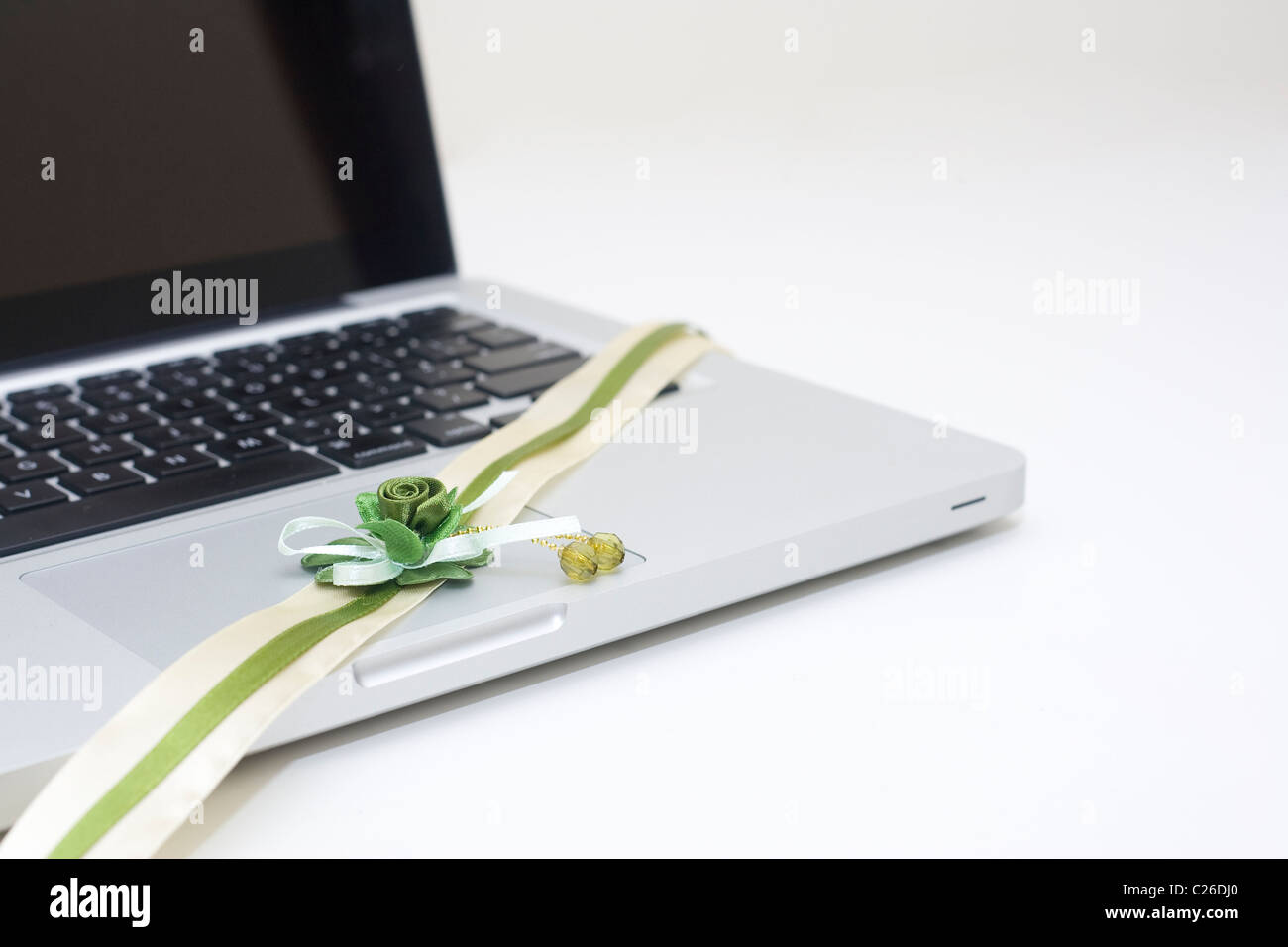 Green ribbon flower on the laptop Stock Photo Alamy