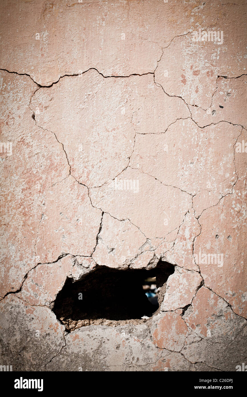 Hole in old cracked wall Stock Photo