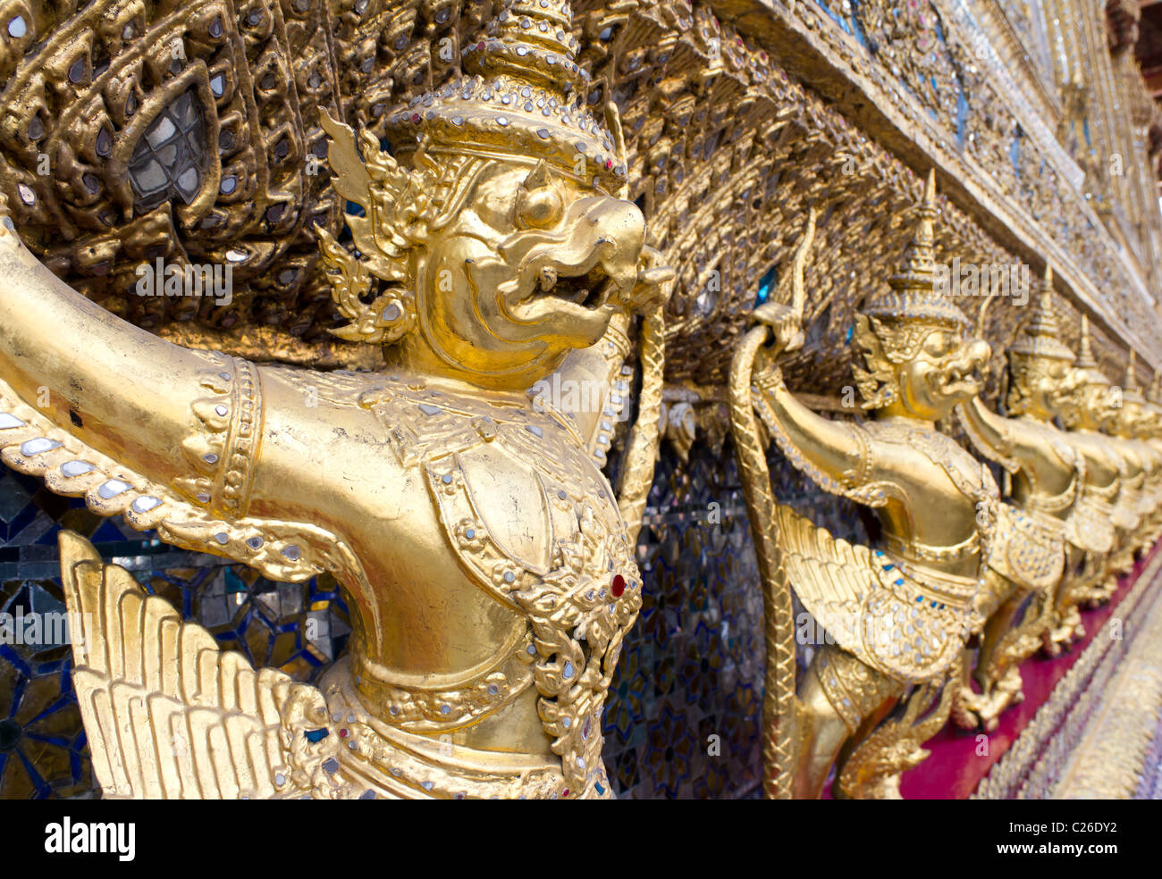 Row of Garuda Statues on the Exterior of the Temple of the Emerald Buddha or Wat Phra Kaew, Grand Palace, Bangkok, Thailand Stock Photo