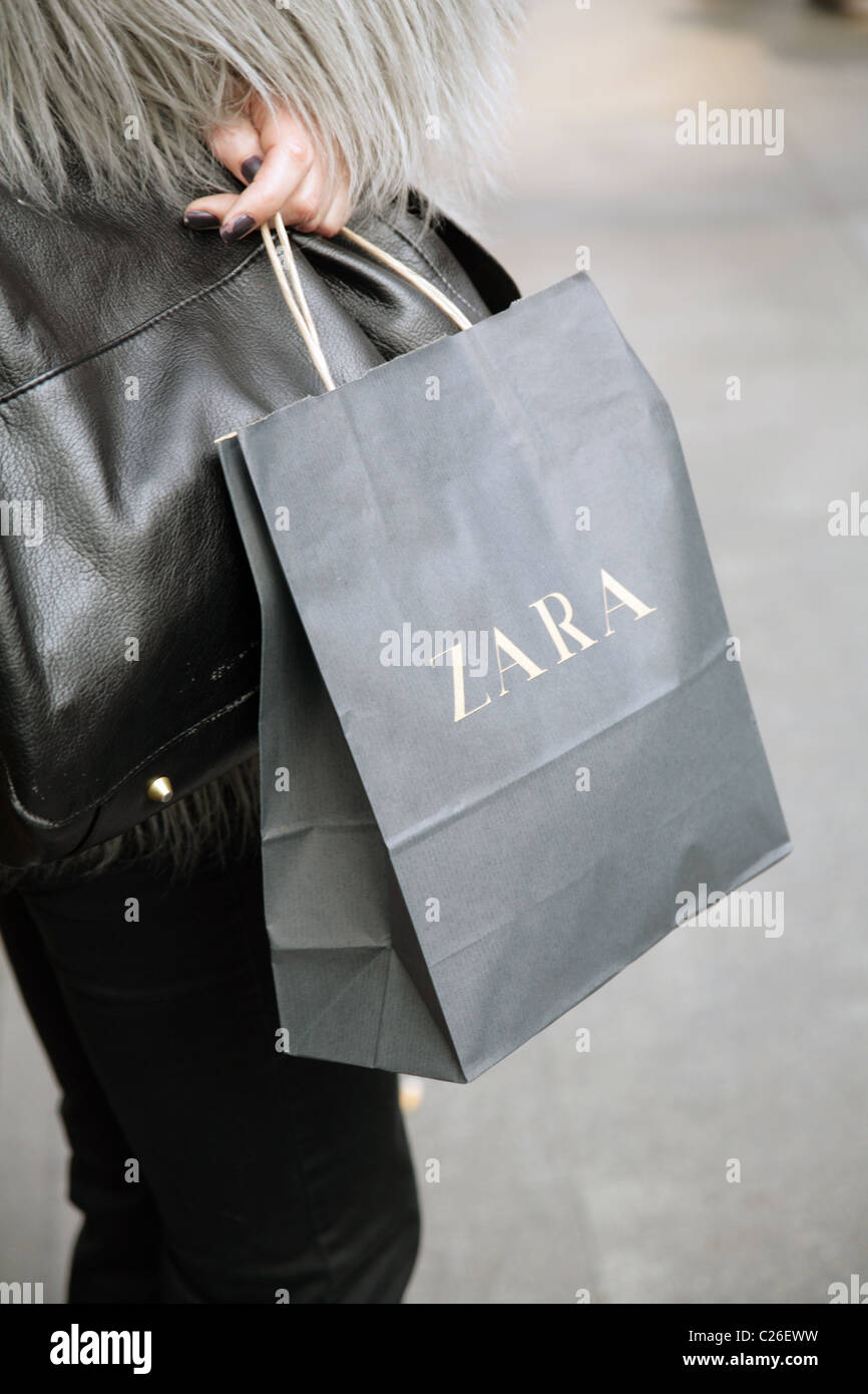Woman holding a Zara shopping bag in 
