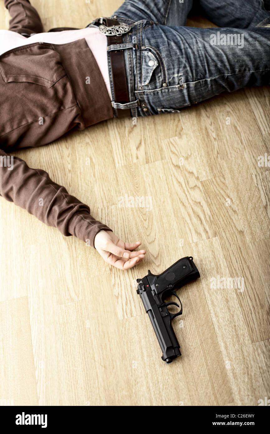 crime scene, dead body on floor and pistol Stock Photo