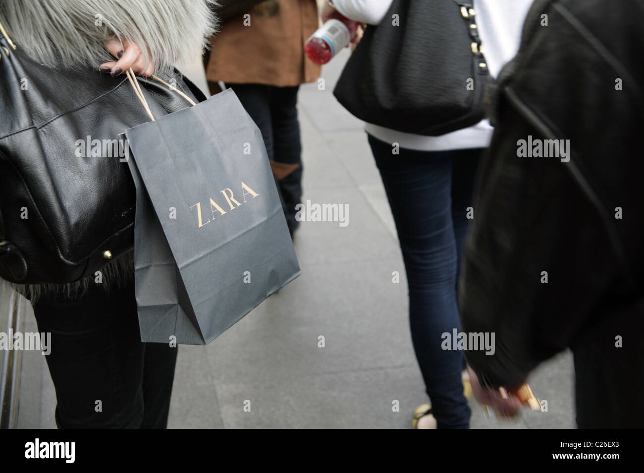 Woman holding a Zara shopping bag in 