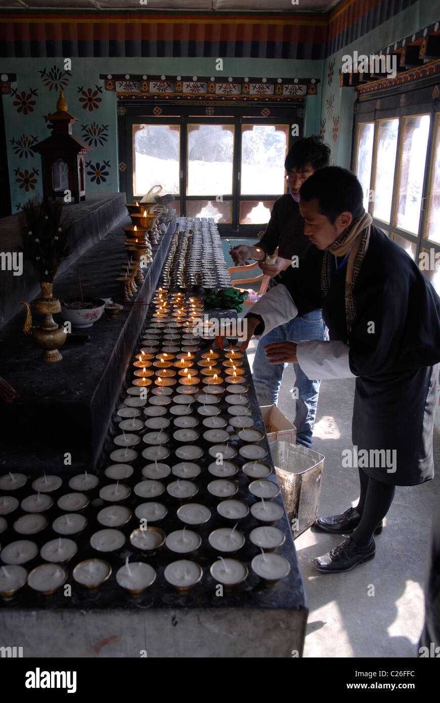 People lighting up candles at Kori La pass, east of Mongar, East Bhutan Stock Photo