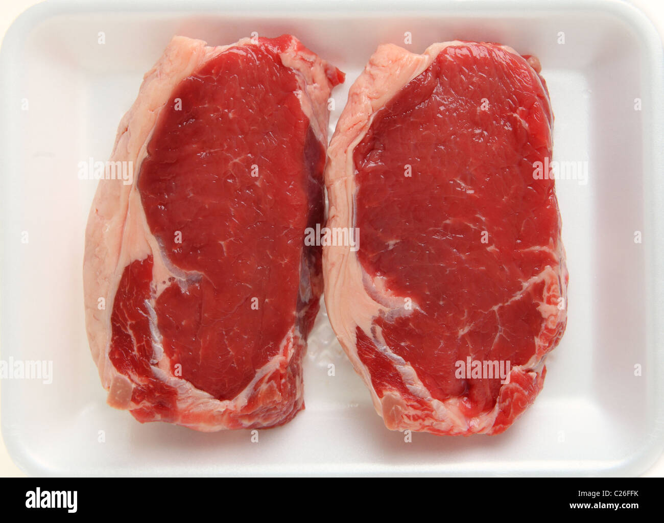 Two raw veal sirloin steaks on a supermarket butchers' tray Stock Photo