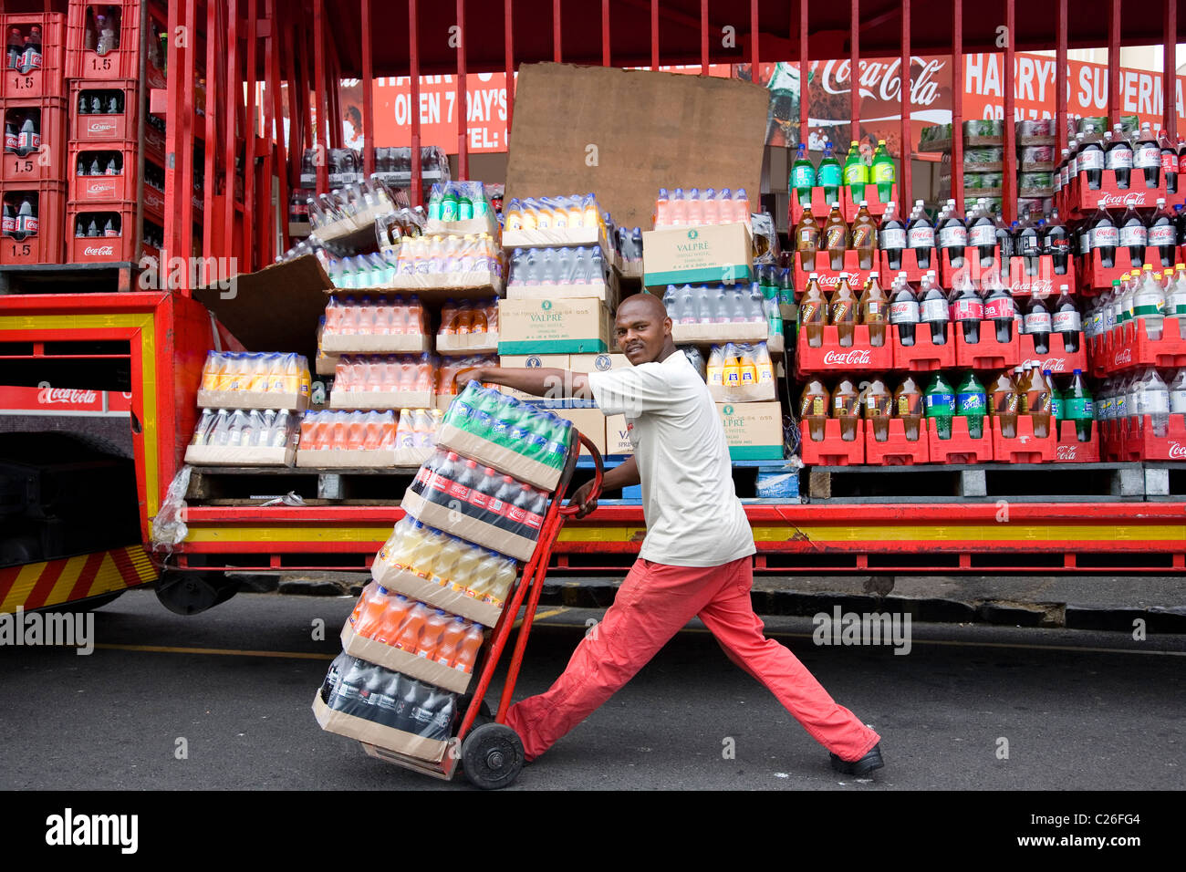 Man delievring goods from Coca Cola truck Stock Photo