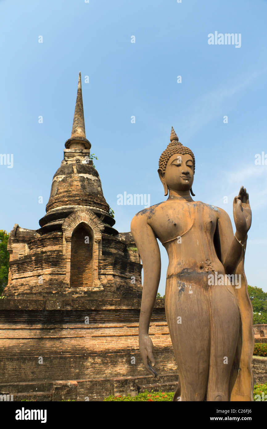 Statue of the Walking Buddha at Wat Sa Si, Part of the Sukothai Historical Park in Thailand Stock Photo