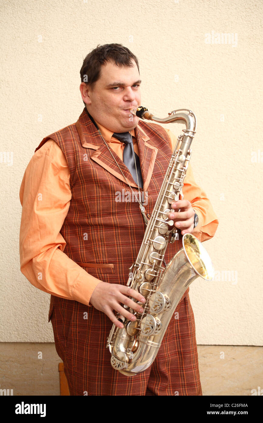 Musician From The Old Time Band Funny Fellows Playing On The Saxophone Musician From The Old Time Band Funny Fellows Playing On The Saxophone