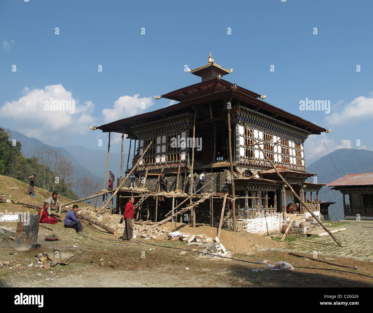 Monastery being restored after an earthquake, East Bhutan, between ...