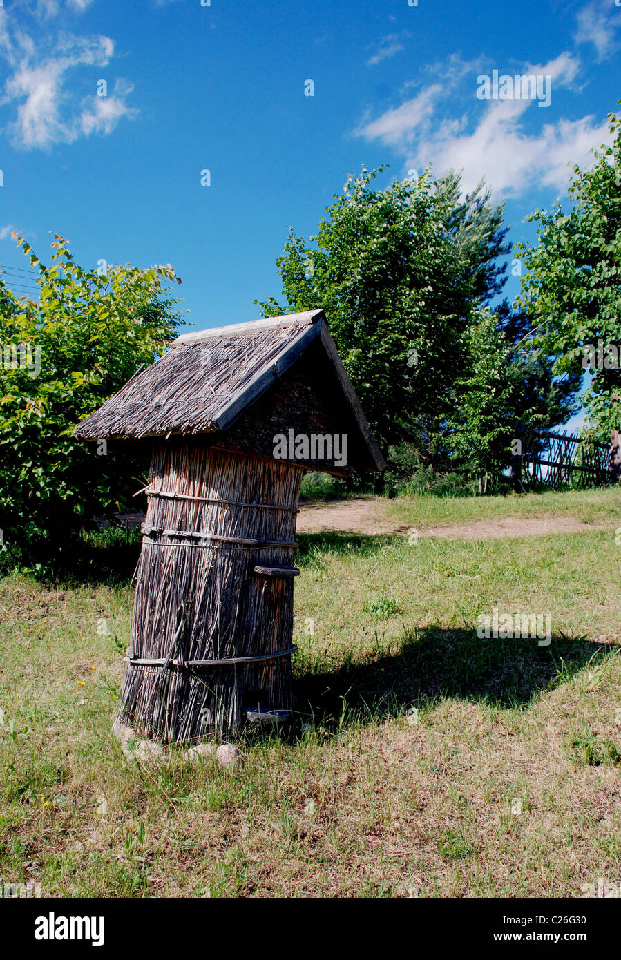 Ancient bee hive with reed covered roof and walls. Beekeeping museum