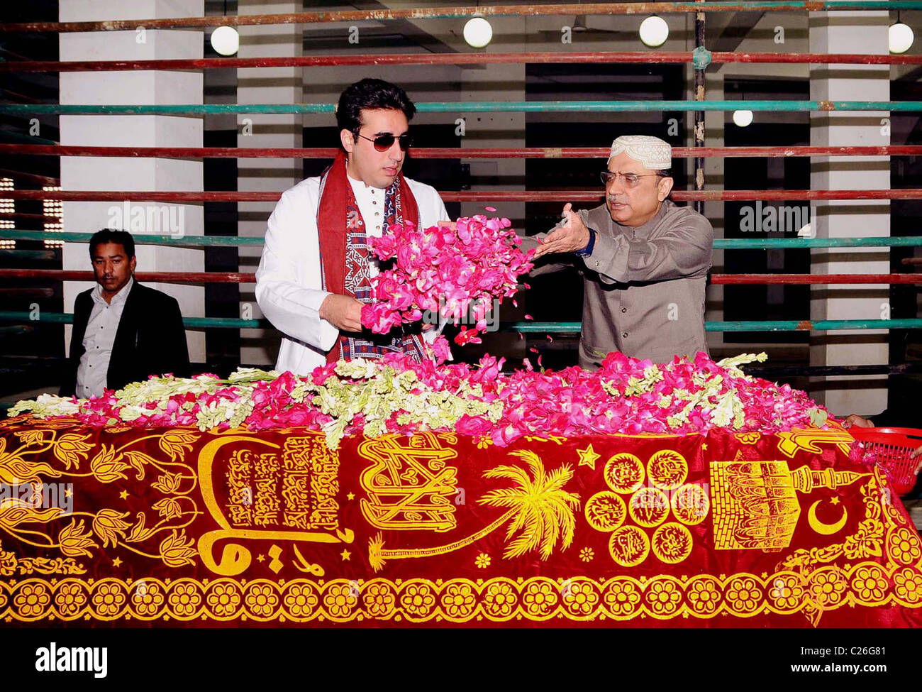 President, Asif Ali Zardari along with Bilawal Bhutto Zardari Chairman of Peoples Party shower rose petals on the Grave Stock Photo