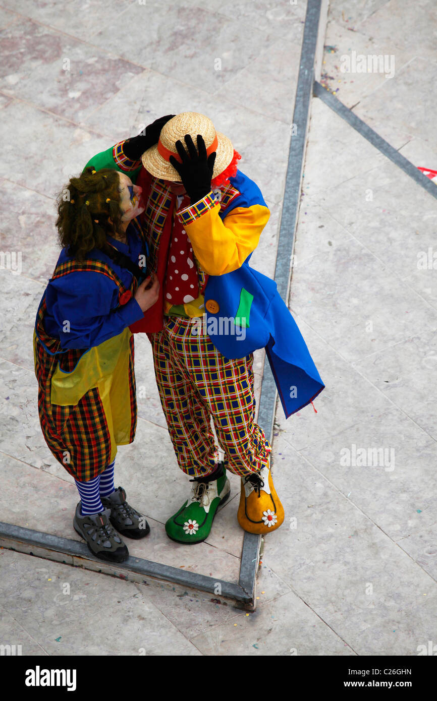 A Man And A Woman Dressed As Two Clowns Chat Closely During The Mardi Stock Photo Alamy