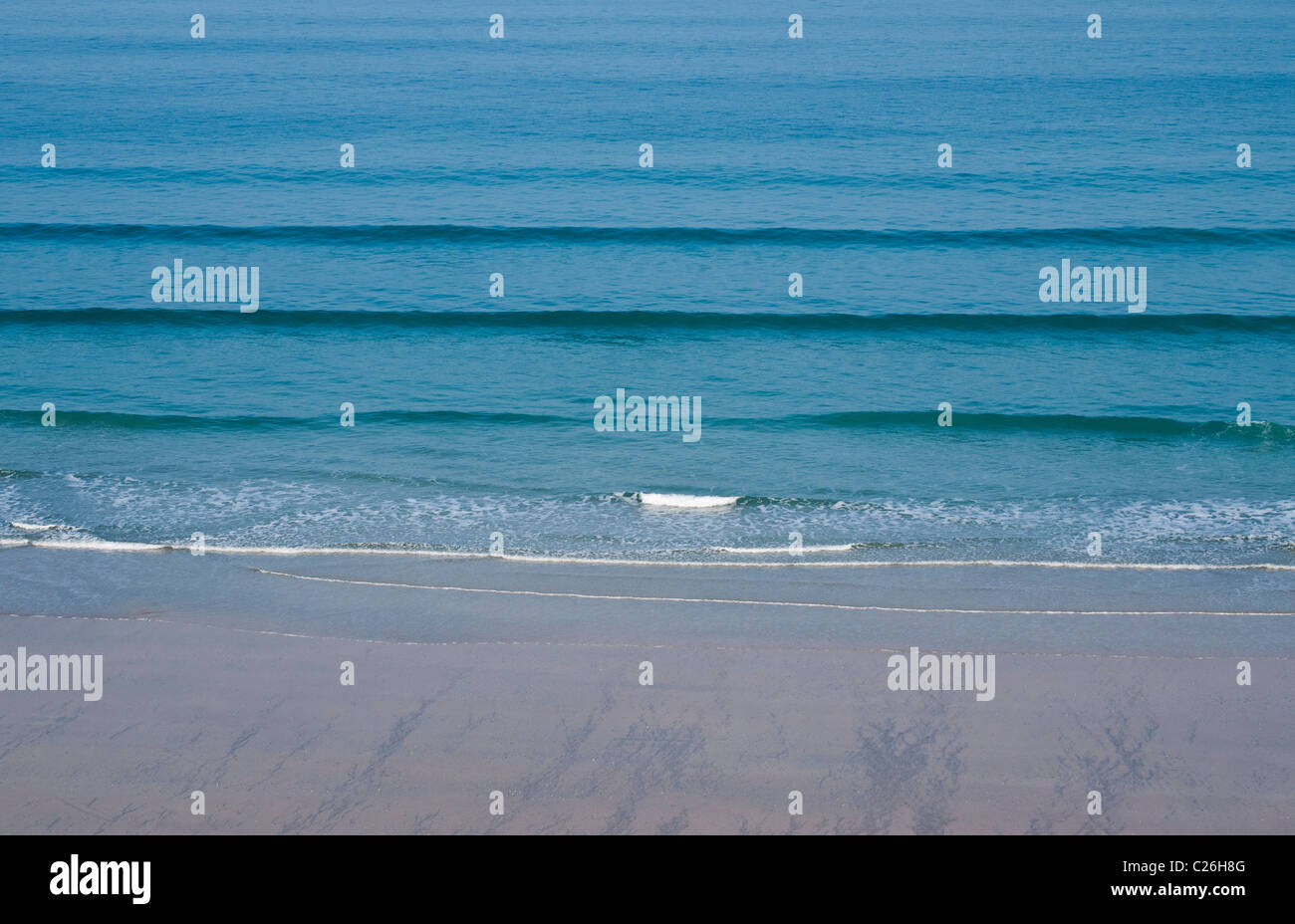 Gentle Waves on a sandy beach at Newquay, Cornwall, UK Stock Photo