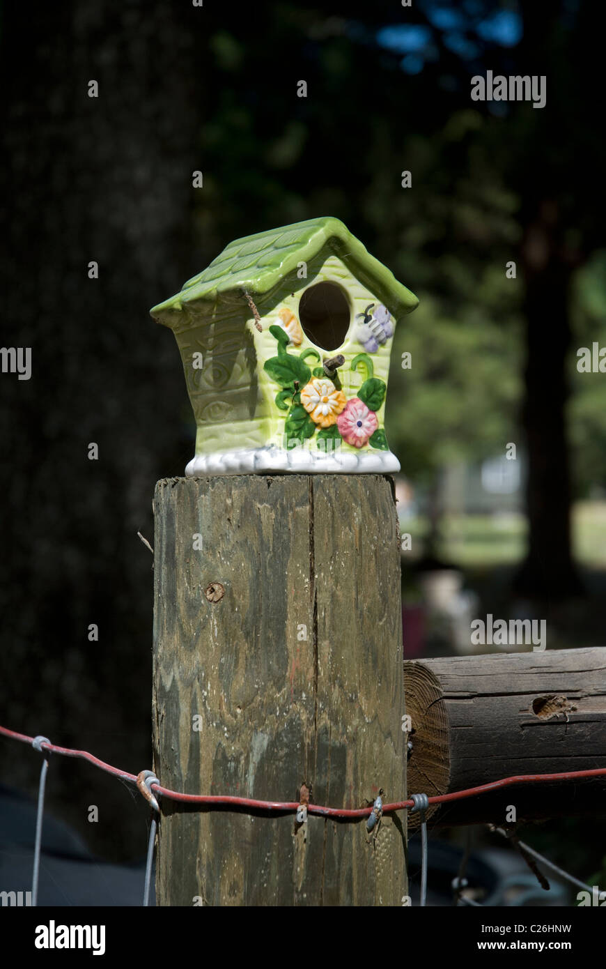 colorful ceramic bird house sits on fencepost Stock Photo - Alamy