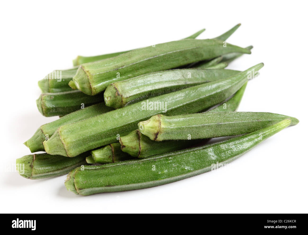 A heap of okra or "ladies fingers" on a white background Stock Photo