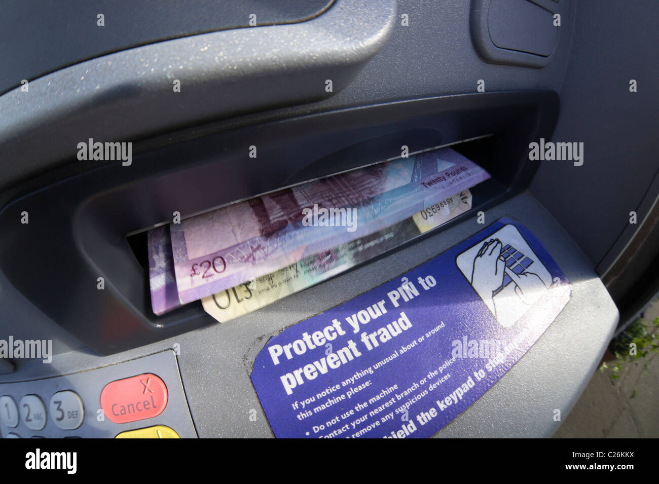 Fifty pounds - notes ejected from ATM cash machine, Scotland. These are Scottish bank notes not English. Stock Photo