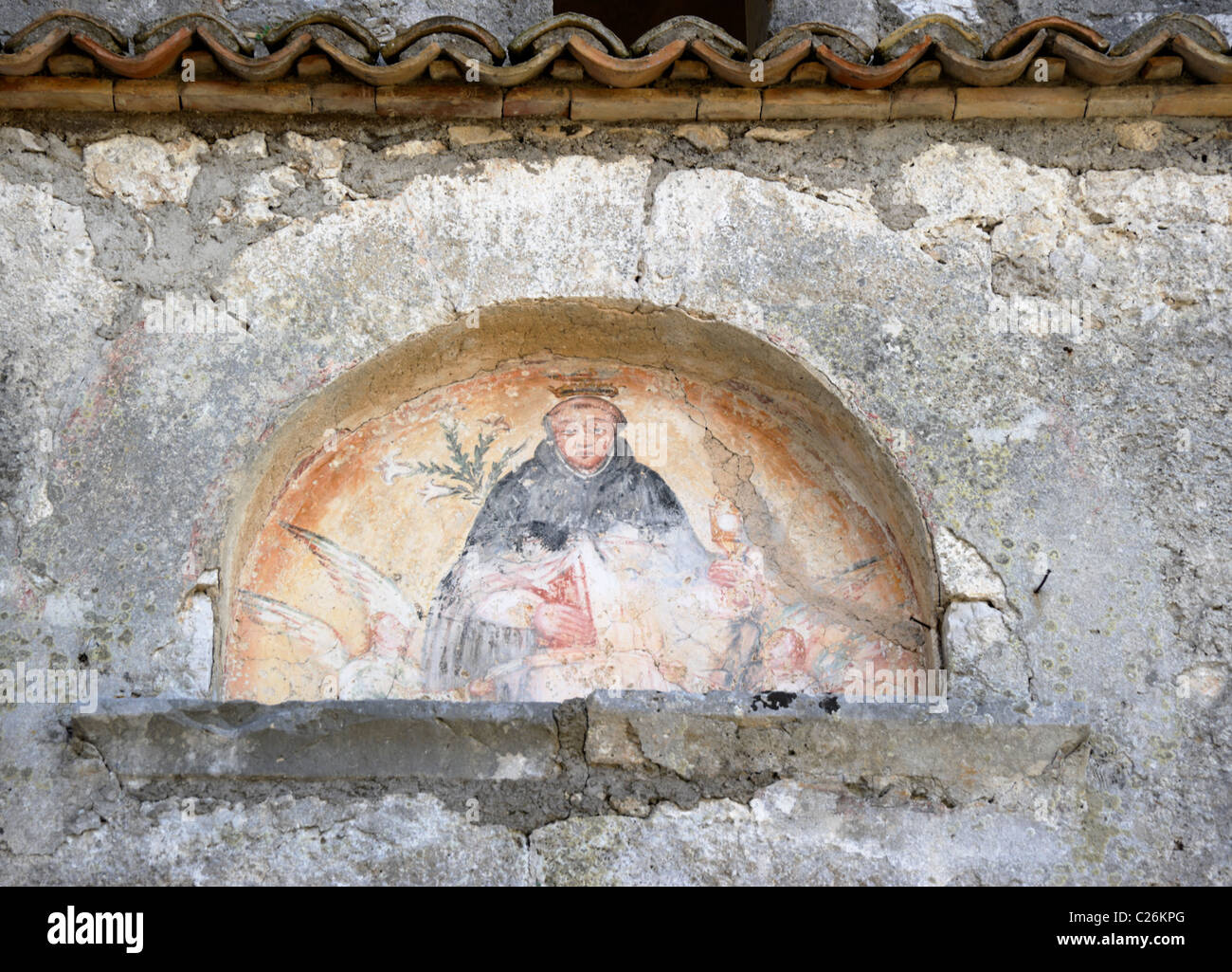 Fresco painting on St Thomas Aquinas medieval church bell tower next to family castle ruins in Roccasecca, Italy. Stock Photo