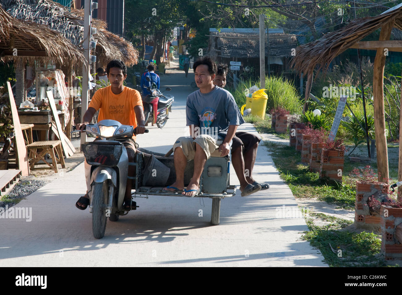 Thai men on a motorbike with a sidecar, Koh Lipe, Thailand Stock Photo