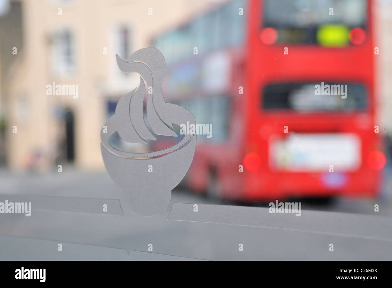 View through a restaurant window of a red double decker bus in Greenwich, London, UK. Stock Photo
