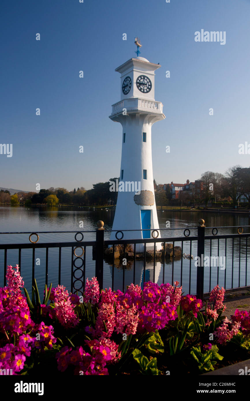 Captain Scott memorial lighthouse at Roath Park Lake with flowers in foreground in spring Cardiff South Wales UK Stock Photo