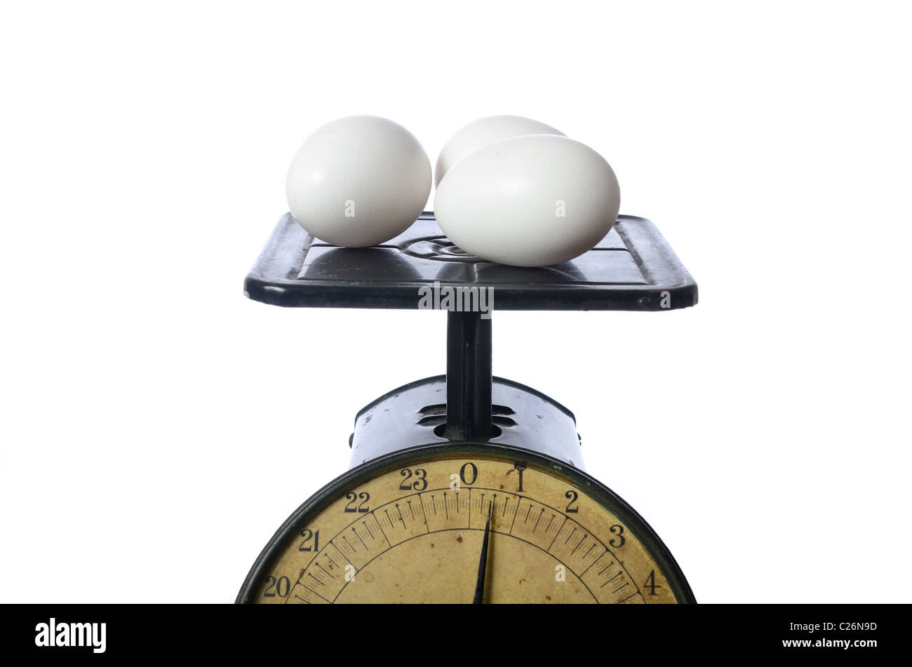 Eggs being weighed on an antique scale. Stock Photo