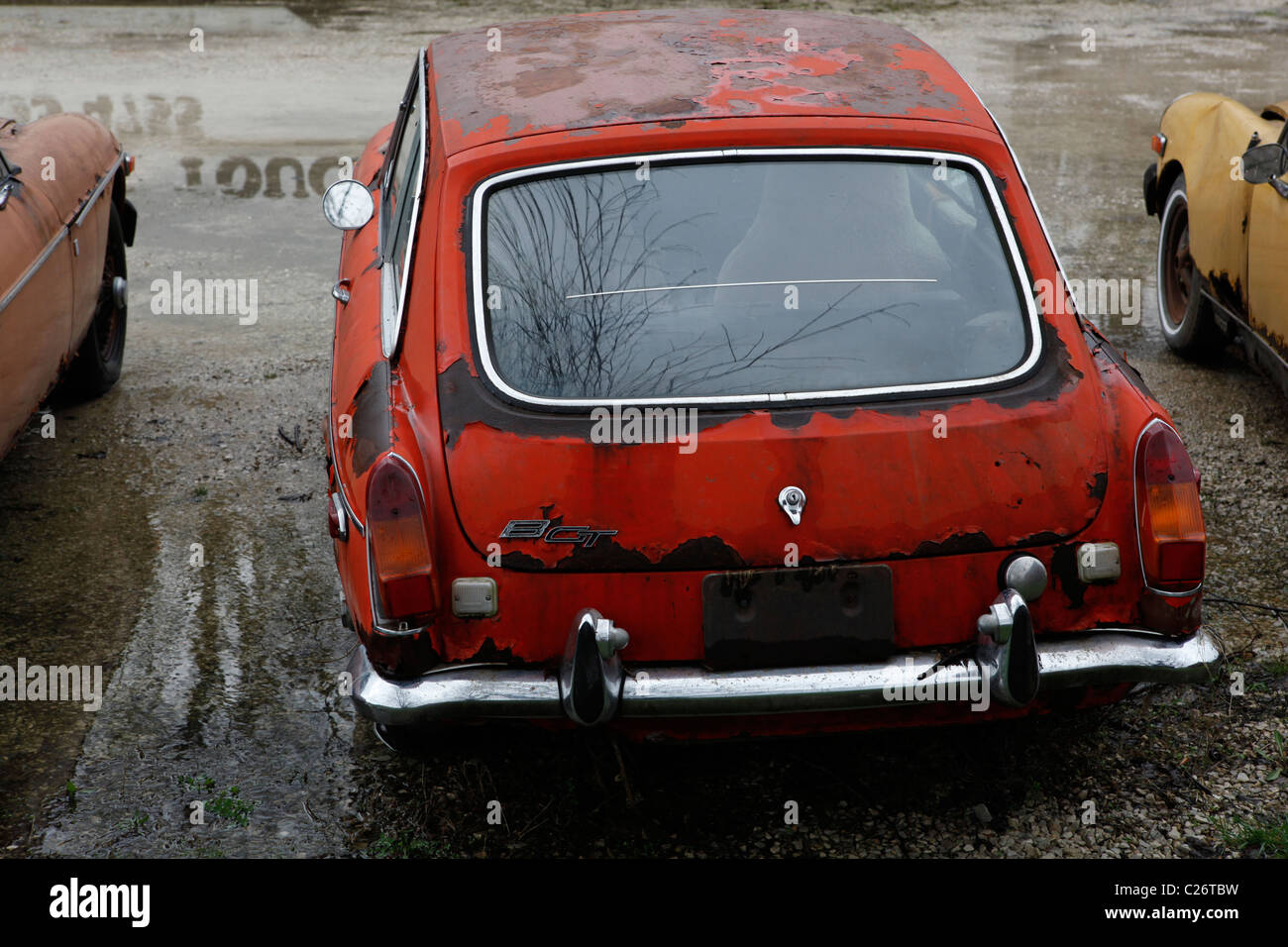 MG British Sportscar sits before auction sale next to a barn in rural Indiana. sports car BGT GT red hatchback Stock Photo