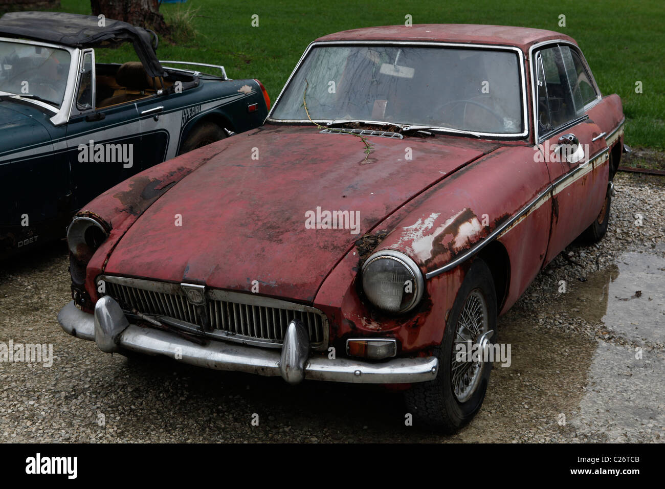 MG British Sportscar sits before auction sale next to a barn in rural Indiana. sports car MGB red Stock Photo