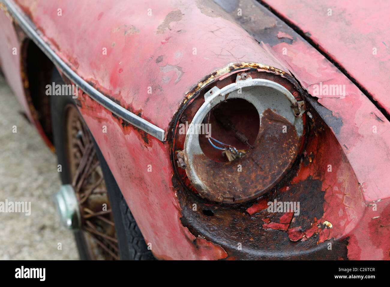 MG British Sportscar sits before auction sale next to a barn in rural Indiana. sports car broken headlight Stock Photo