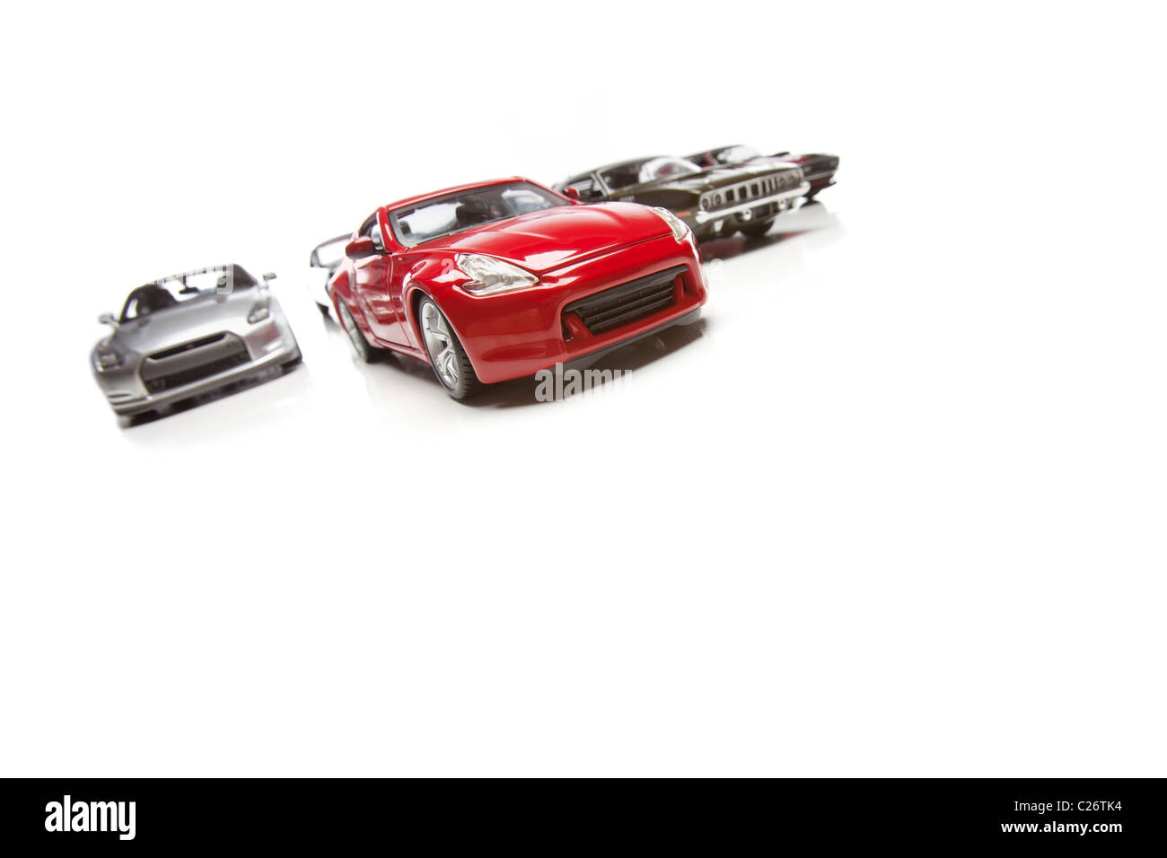 Several Sports Cars Racing Isolated on a White Background. Stock Photo