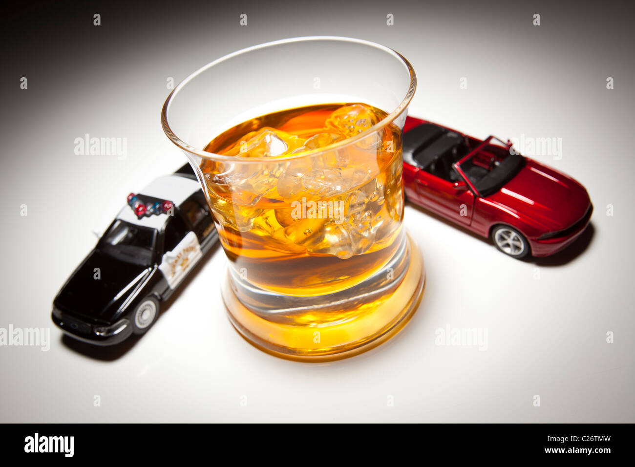 Police and Sports Car Next to Alcoholic Drink Under Spot Light. Stock Photo