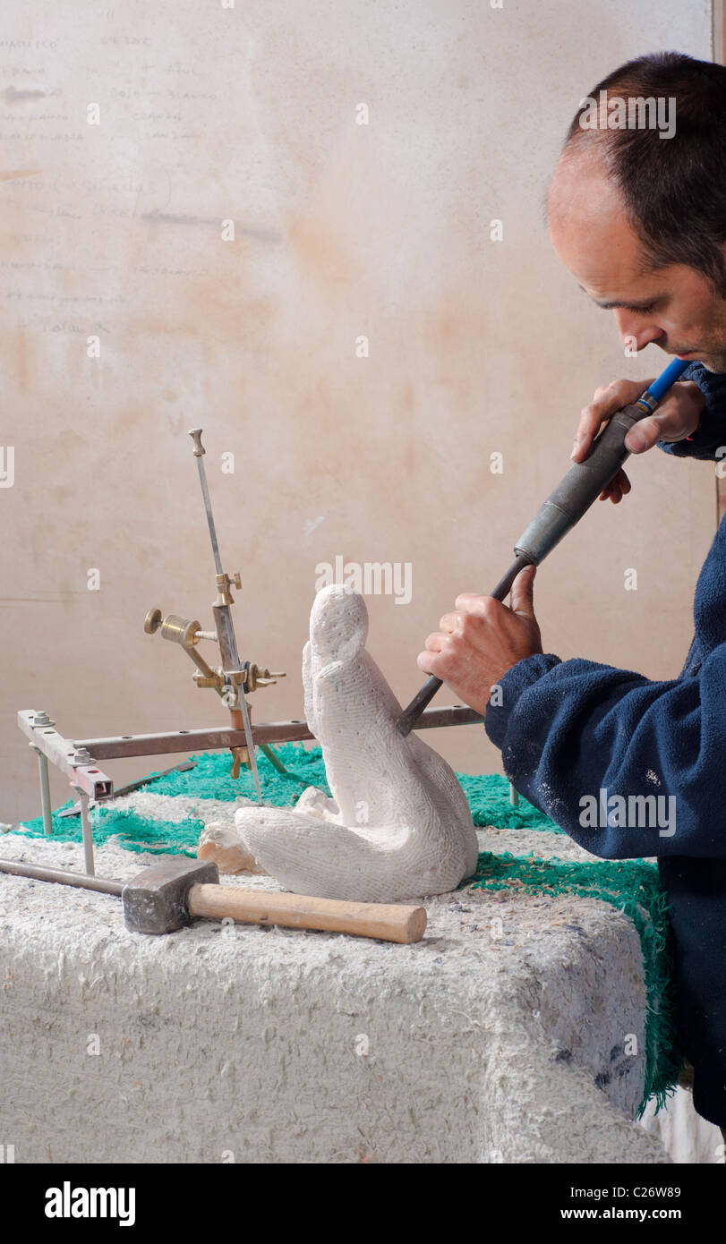Sculptor working on his art at his Stock Photo Alamy