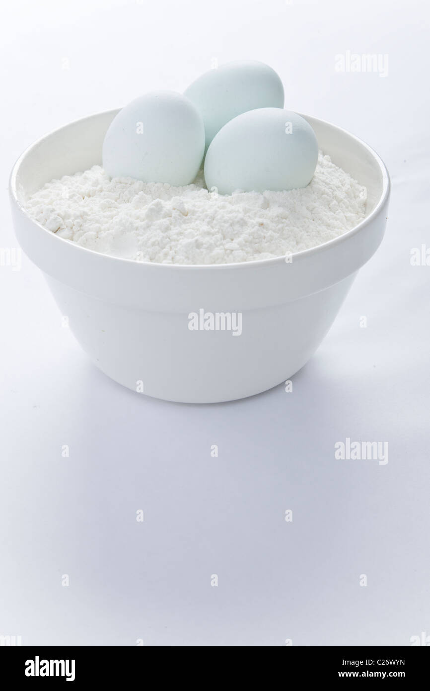 Mixing Bowl with Eggs and Flour Stock Photo
