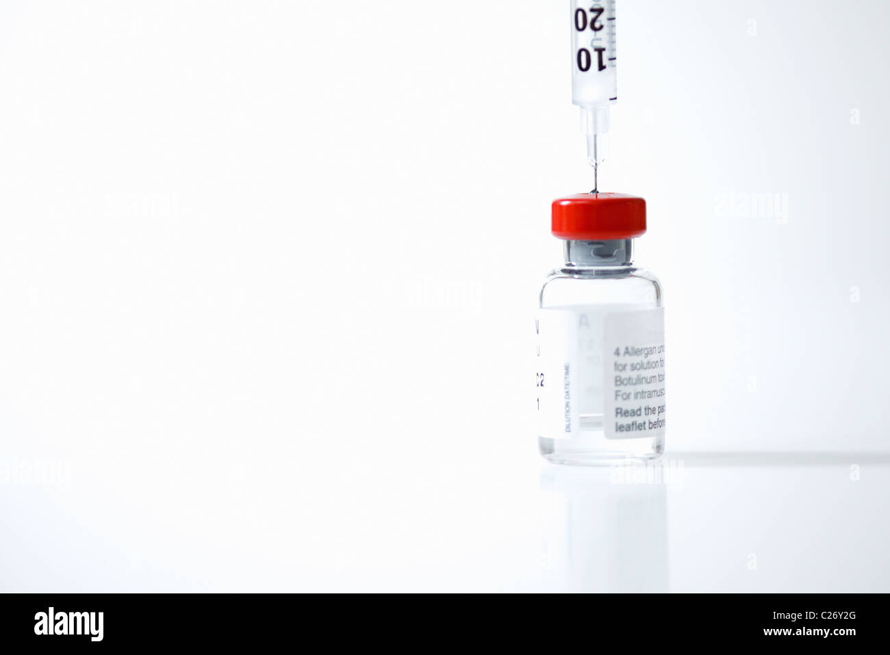 Hypodermic Needle Inserted in Medicine Vial Stock Photo