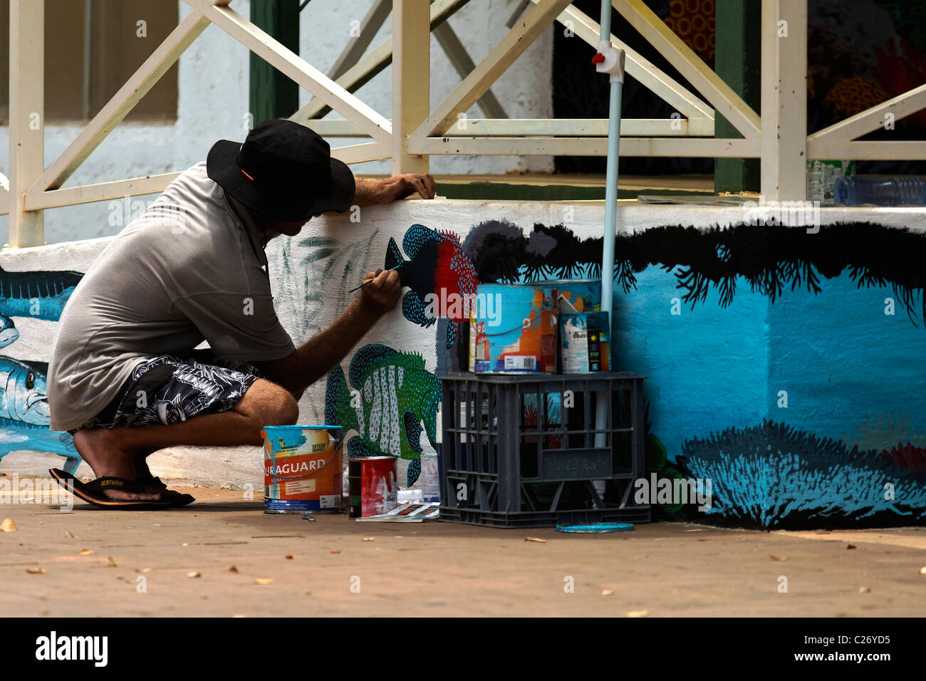 Sign Writer painting a wall, Exmouth Western Australia Stock Photo