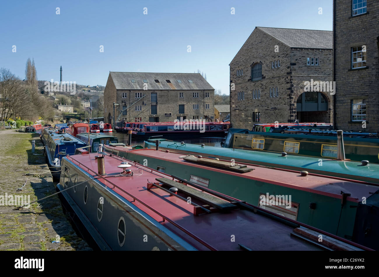 canal boats at moorings on the rochdale canal in the pennine town of sowerby bridge in calderdale west yorkshire. Stock Photo