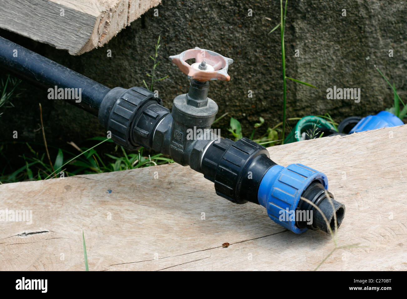 A tap on a pipe from a well on which to attach a water pump Stock Photo