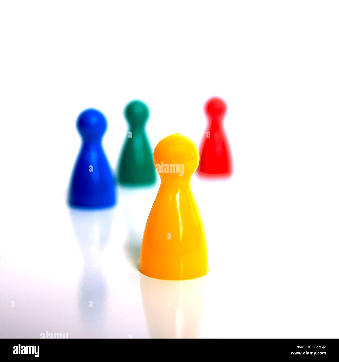 Four game pieces from a board game - team leader / difference concept. Stock Photo