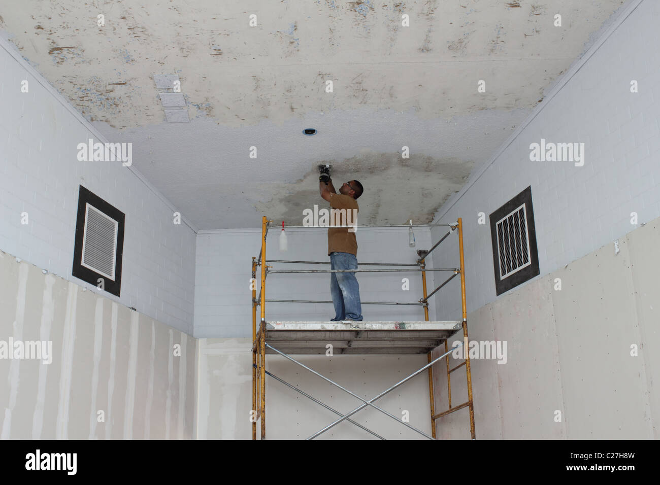 Man repairing ceiling at Barton Springs Pool building Stock Photo