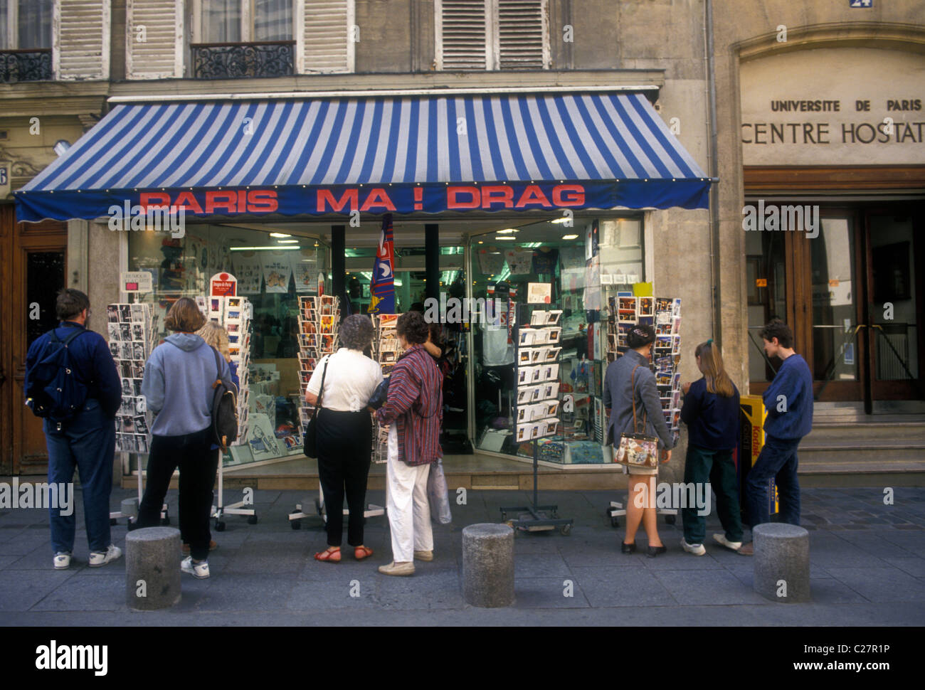 People tourists shoppers shopping at souvenir shop store Saint-Michel district Latin Quarter Left Bank Paris France Europe Stock Photo